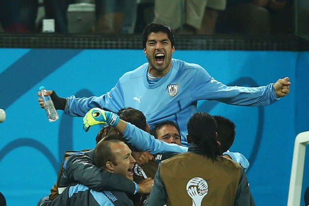 SAO PAULO, BRAZIL - JUNE 19:  Luis Suarez of Uruguay is lifted up by teammates in celebration after defeating England 2-1 during the 2014 FIFA World Cup Brazil Group D match between Uruguay and England at Arena de Sao Paulo on June 19, 2014 in Sao Paulo, Brazil.  (Photo by Clive Rose/Getty Images)