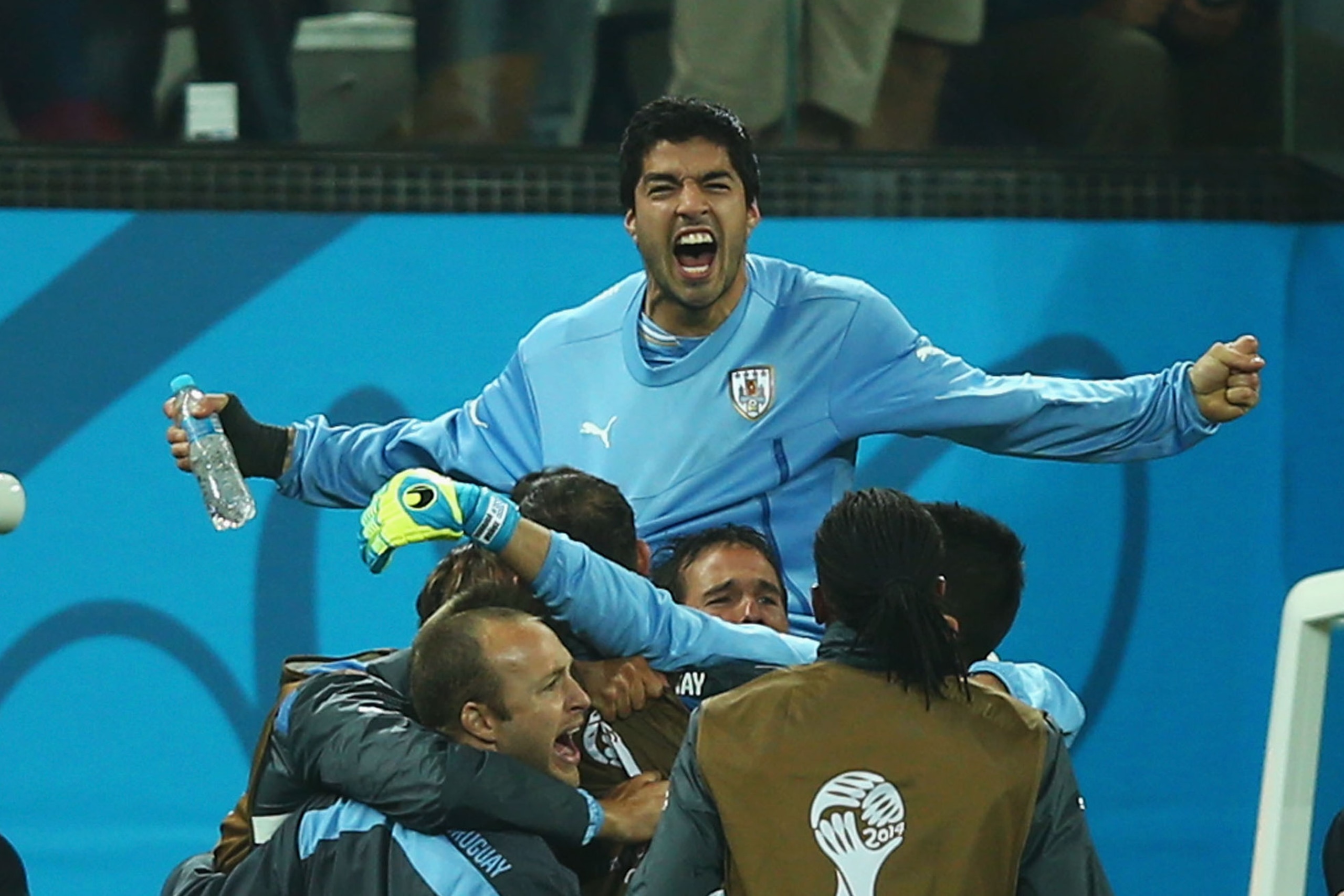 SAO PAULO, BRAZIL - JUNE 19:  Luis Suarez of Uruguay is lifted up by teammates in celebration after defeating England 2-1 during the 2014 FIFA World Cup Brazil Group D match between Uruguay and England at Arena de Sao Paulo on June 19, 2014 in Sao Paulo, Brazil.  (Photo by Clive Rose/Getty Images)