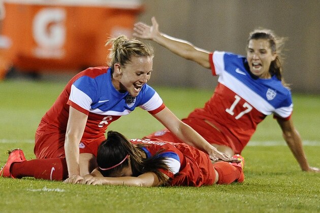 United States' Amy Rodriguez, left, and Tobin Heath, right, congratulate Alex Morgan, center, on her goal during the second half of a women's friendly soccer match against France, Thursday, June 19, 2014, in East Hartford, Conn. The final score was 2-2. (AP Photo/Jessica Hill)