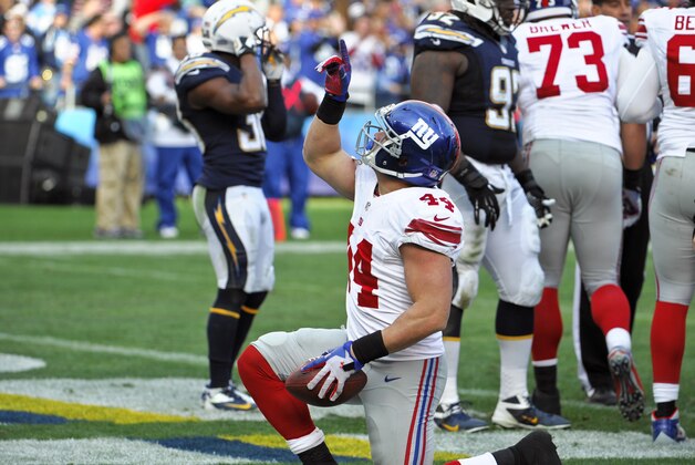New York Giants running back Peyton Hillis points after his 1-yard touchdown run against the San Diego Chargers during the second half of an NFL football game on Sunday, Dec. 8, 2013, in San Diego. (AP Photo/Denis Poroy)