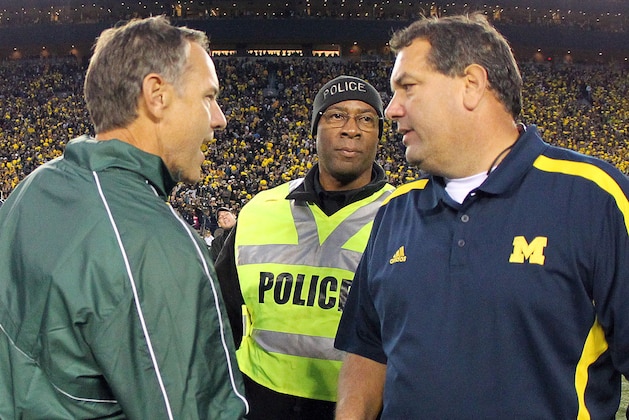 October 20, 2012; Ann Arbor, MI, USA; Michigan Wolverines head coach Brady Hoke and Michigan State Spartans head coach Mark Dantonio shake hands after game at Michigan Stadium. Michigan won 12-10.    Mandatory Credit: Mike Carter-USA TODAY Sports