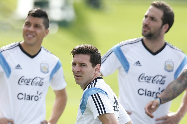 Argentina's Lionel Messi, center, stands with teammates Enzo Perez, left, and Gonzalo Higuain, right, during a training session in Vespasiano, near Belo Horizonte, Brazil, Wednesday, June 18, 2014.  Argentina plays in group F of the 2014 soccer World Cup. (AP Photo/Victor R. Caivano)