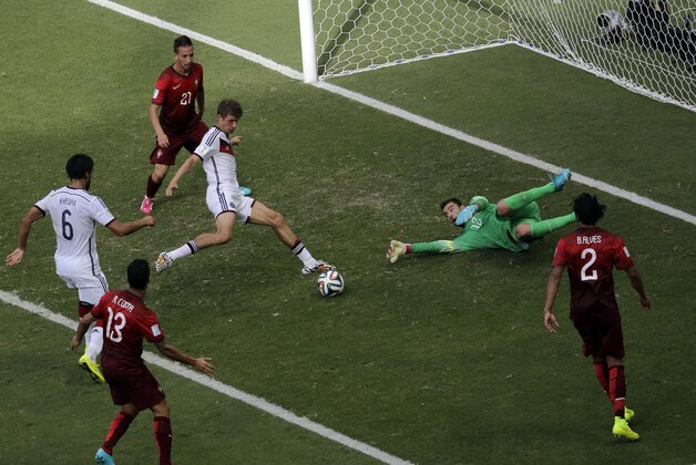 Germany's Thomas Mueller scores his team's fourth goal and his third during the group G World Cup soccer match between Germany and Portugal at the Arena Fonte Nova in Salvador, Brazil, Monday, June 16, 2014.  (AP Photo/Christophe Ena)
