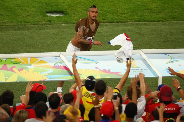 RIO DE JANEIRO, BRAZIL - JUNE 18: Arturo Vidal of Chile throws his jersey into the crowd after defeating Spain 2-0 during the 2014 FIFA World Cup Brazil Group B match between Spain and Chile at Maracana on June 18, 2014 in Rio de Janeiro, Brazil.  (Photo by Julian Finney/Getty Images)