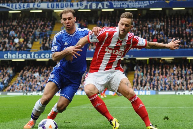 LONDON, ENGLAND - APRIL 05:  Branislav Ivanovic of Chelsea and Marko Arnautovic of Stoke City compete for the ball during the Barclays Premier League match between Chelsea and Stoke City at Stamford Bridge on April 5, 2014 in London, England.  (Photo by Mike Hewitt/Getty Images)