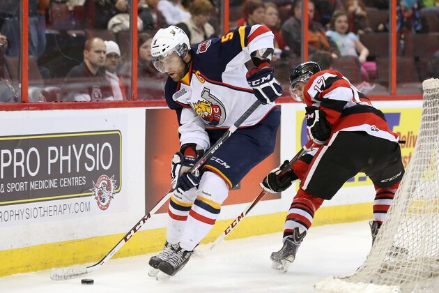 OTTAWA, ON - MARCH 13:  Aaron Ekblad #5 of the Barrie Colts skates with the puck past Travis Konecny #17 of the Ottawa 67's during an OHL game at Canadian Tire Centre on March 13, 2014 in Ottawa, Ontario, Canada.  (Photo by Jana Chytilova/Freestyle Photography/Getty Images)
