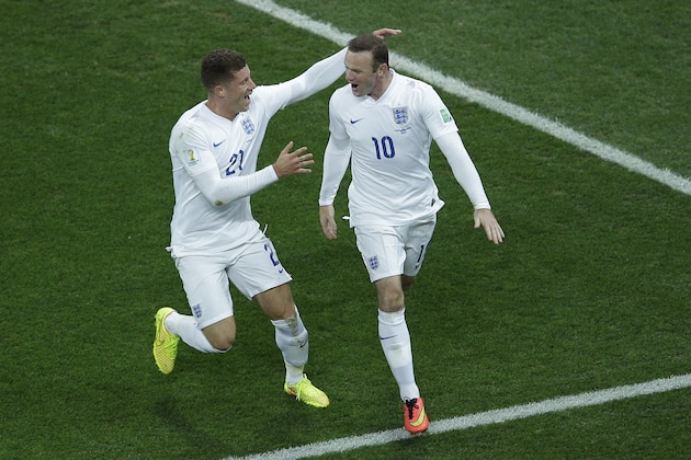 England's Wayne Rooney, right, celebrates with teammate Ross Barkley after scoring his side's first goal during the group D World Cup soccer match between Uruguay and England at the Itaquerao Stadium in Sao Paulo, Brazil, Thursday, June 19, 2014.  (AP Photo/Michael Sohn)
