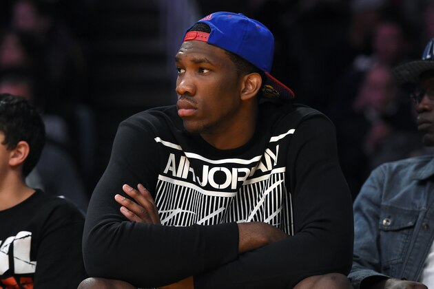 Kansas center Joel Embiid watches the Los Angeles Lakers play the Memphis Grizzlies in an NBA basketball game, Sunday, April 13, 2014, in Los Angeles. The Grizzlies won 102-90. (AP Photo/Mark J. Terrill)