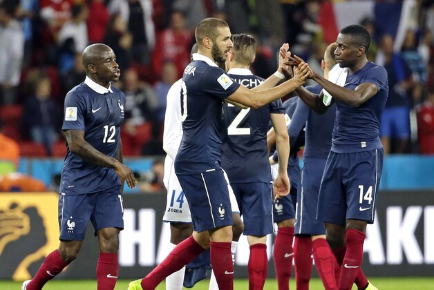 France's Karim Benzema, center, is congratulated by France's Blaise Matuidi (14), Rio Mavuba (12) and other teammates after their 3-0 victory over Honduras during the group E World Cup soccer match between France and Honduras at the Estadio Beira-Rio in Porto Alegre, Brazil, Sunday, June 15, 2014.(AP Photo/Fernando Vergara)