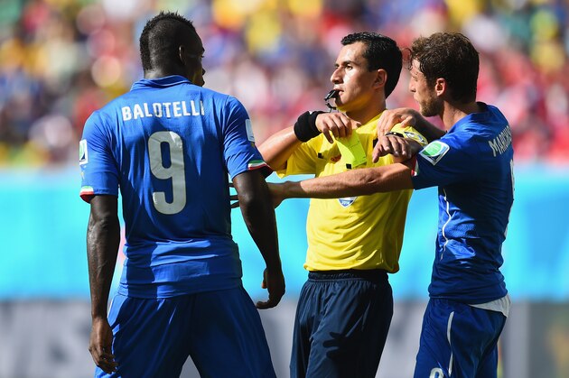 RECIFE, BRAZIL - JUNE 20:  Referee Enrique Osses gives Mario Balotelli of Italy a yellow card during the 2014 FIFA World Cup Brazil Group D match between Italy and Costa Rica at Arena Pernambuco on June 20, 2014 in Recife, Brazil.  (Photo by Jamie McDonald/Getty Images)