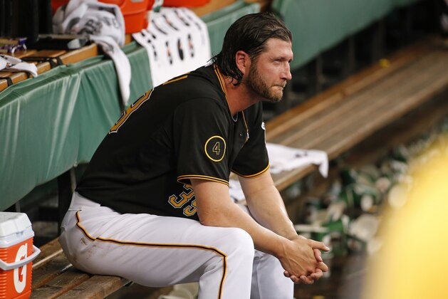 Pittsburgh Pirates relief pitcher Jason Grilli sits in the dugout after giving up a solo home run to Cincinnati Reds' Devin Mesoraco during the ninth inning of a baseball game in Pittsburgh, Thursday, June 19, 2014. The Pirates won 4-3 in 12 innings. (AP Photo/Gene J. Puskar)