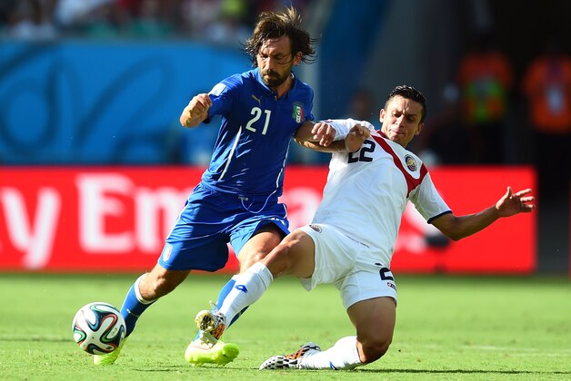 RECIFE, BRAZIL - JUNE 20:  Andrea Pirlo of Italy and Jose Miguel Cubero of Costa Rica compete for the ball during the 2014 FIFA World Cup Brazil Group D match between Italy and Costa Rica at Arena Pernambuco on June 20, 2014 in Recife, Brazil.  (Photo by Jamie McDonald/Getty Images)