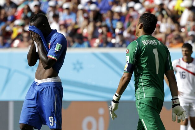 Italy's Mario Balotelli, left, wipes his face in front of Costa Rica's goalkeeper Keylor Navas during the group D World Cup soccer match between Italy and Costa Rica at the Arena Pernambuco in Recife, Brazil, Friday, June 20, 2014.  (AP Photo/Ricardo Mazalan)