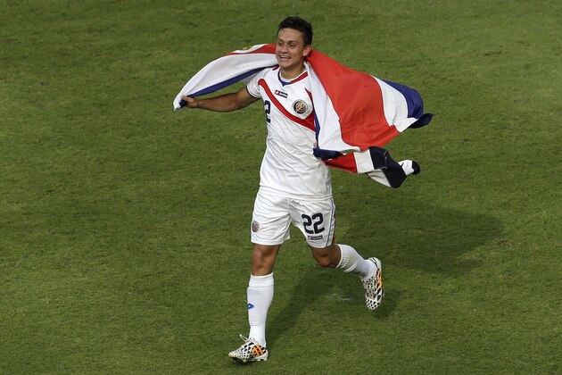 Costa Rica's Jose Miguel Cubero celebrates with his country's flag after winning the group D World Cup soccer match between Italy and Costa Rica at the Arena Pernambuco in Recife, Brazil, Friday, June 20, 2014.  (AP Photo/Hassan Ammar)