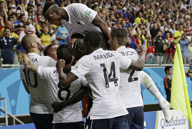French players celebrate after France's Karim Benzema, left,  scored his side's fourth goal during the group E World Cup soccer match between Switzerland and France at the Arena Fonte Nova in Salvador, Brazil, Friday, June 20, 2014.    (AP Photo/Christophe Ena)