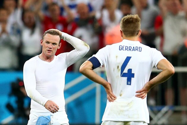SAO PAULO, BRAZIL - JUNE 19:  A dejected Wayne Rooney (L) and Steven Gerrard of England look on after being defeated by Uruguay 2-1 during the 2014 FIFA World Cup Brazil Group D match between Uruguay and England at Arena de Sao Paulo on June 19, 2014 in Sao Paulo, Brazil.  (Photo by Julian Finney/Getty Images)