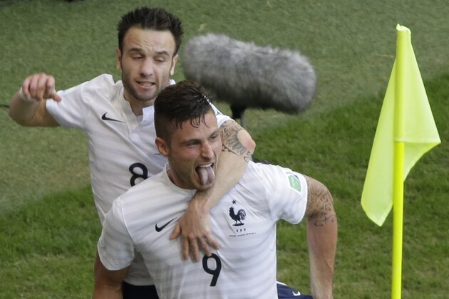 France's Mathieu Valbuena, left, celebrates with his teammate Olivier Giroud after scoring his side's third goal during the group E World Cup soccer match between Switzerland and France at the Arena Fonte Nova in Salvador, Brazil, Friday, June 20, 2014. (AP Photo/Sergei Grits)