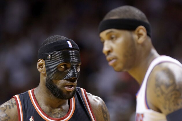 Miami Heat small forward LeBron James, left, and New York Knicks small forward Carmelo Anthony (7) are shown during an NBA basketball game against the New York Knicks in Miami, Thursday, Feb. 27, 2014. (AP Photo/Alan Diaz)