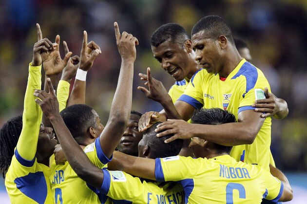 Ecuador's Enner Valencia, center, celebrates with teammates after scoring his team's second goal during the group E World Cup soccer match between Honduras and Ecuador at the Arena da Baixada in Curitiba, Brazil, Friday, June 20, 2014. (AP Photo/Michael Sohn)