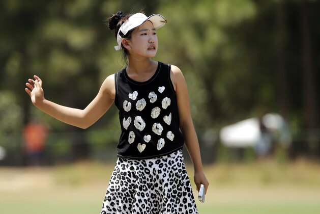 Lucy Li reacts after her approach shot on the second hole during the second round of the U.S. Women's Open golf tournament in Pinehurst, N.C., Friday, June 20, 2014. (AP Photo/Chuck Burton)