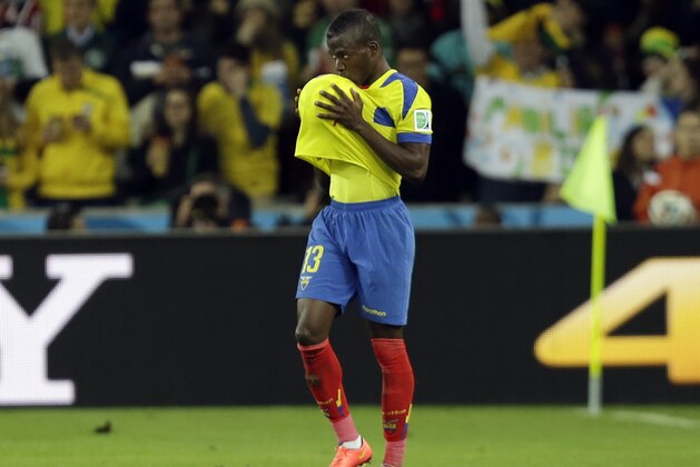 Ecuador's Enner Valencia kisses the ball under his jersey after scoring his side's second goal with a header during the group E World Cup soccer match between Honduras and Ecuador at the Arena da Baixada in Curitiba, Brazil, Friday, June 20, 2014. (AP Photo/Fernando Vergara)