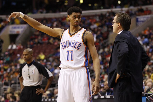 Oklahoma City Thunder's Jeremy Lamb, left, talks with head coach Scott Brooks, right, during the first half of an NBA basketball game, Saturday, Jan. 25, 2014, in Philadelphia. The Thunder won 103-91. (AP Photo/Chris Szagola)