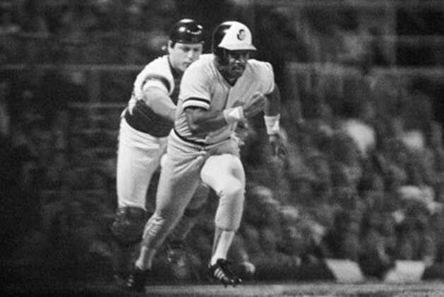 Chicago White Sox catcher Carlton Fisk, left, chases Baltimore Orioles Al Bumbry toward first base after a dropped third strike in the first inning of Game 3 of the American League playoffs in Chicago, Oct. 7, 1983. Fisk tagged Bumbry out. (AP Photo/Bob Daugherty)
