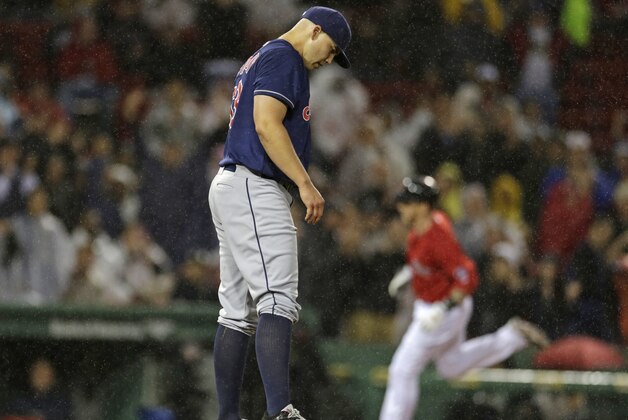 Cleveland Indians starting pitcher Justin Masterson, foreground, waits on the mound as Boston Red Sox' Mike Carp rounds third on a three-run home run during the second inning of a baseball game at Fenway Park in Boston, Friday, May 24, 2013. (AP Photo/Charles Krupa)