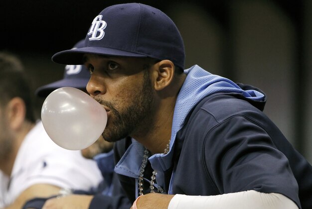 Jun 17, 2014; St. Petersburg, FL, USA; Tampa Bay Rays starting pitcher David Price (14) blows a bubble gum bubble in the dugout against the Baltimore Orioles at Tropicana Field. Baltimore Orioles defeated the Tampa Bay Rays 7-5. Mandatory Credit: Kim Klement-USA TODAY Sports