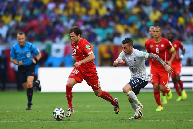 SALVADOR, BRAZIL - JUNE 20: Admir Mehmedi of Switzerland dribbles pas Mathieu Debuchy of France during the 2014 FIFA World Cup Brazil Group E match between Switzerland and France at Arena Fonte Nova on June 20, 2014 in Salvador, Brazil. (Photo by Christopher Lee/Getty Images) SALVADOR, BRAZIL - JUNE 20: Admir Mehmedi of Switzerland dribbles pas Mathieu Debuchy of France during the 2014 FIFA World Cup Brazil Group E match between Switzerland and France at Arena Fonte Nova on June 20, 2014 in Salvador, Brazil. (Photo by Christopher Lee/Getty Images)