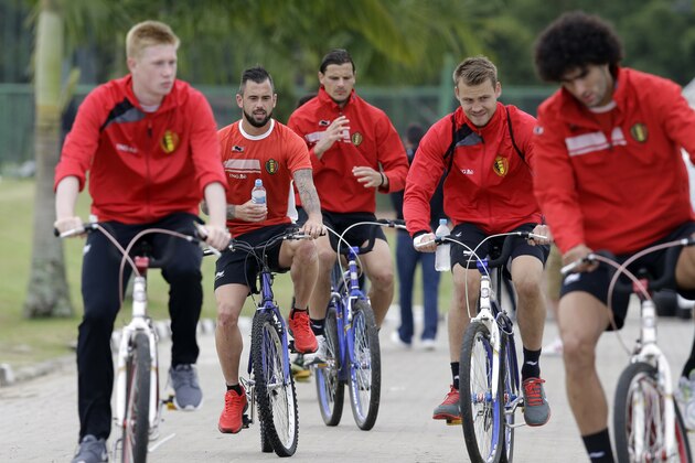 Belgian players ride bicycles as they leave at the end of a training session in Mogi Das Cruzes, Brazil, Thursday, June 19, 2014. Belgium play in group H of the 2014 soccer World Cup. (AP Photo/Andrew Medichini)