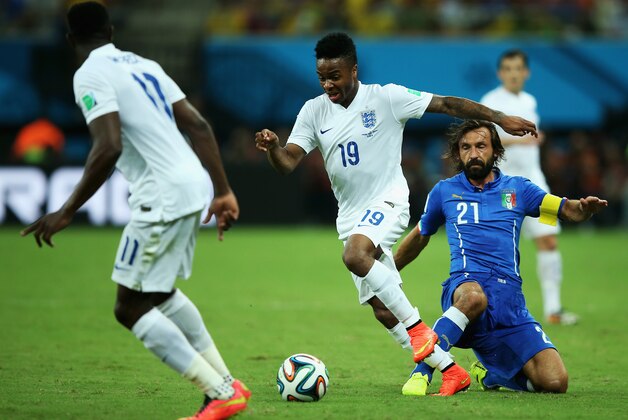MANAUS, BRAZIL - JUNE 14:  Raheem Sterling of England dribbles past Andrea Pirlo of Italy during the 2014 FIFA World Cup Brazil Group D match between England and Italy at Arena Amazonia on June 14, 2014 in Manaus, Brazil.  (Photo by Richard Heathcote/Getty Images)