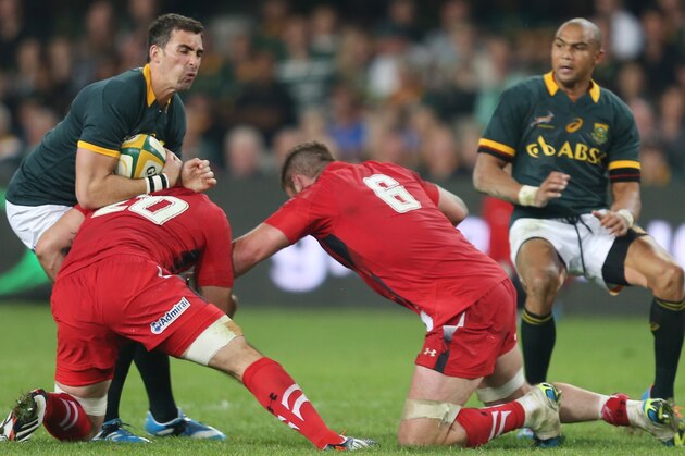 DURBAN, SOUTH AFRICA - JUNE 14: Ruan Pienaar of South Africa is tackled back by Josh Turnbull of the Wales during the Incoming Tour match between South Africa and Wales at Growthpoint Kings Park on June 14, 2014 in Durban, South Africa. (Photo by Steve Haag/Gallo Images/Getty Images)