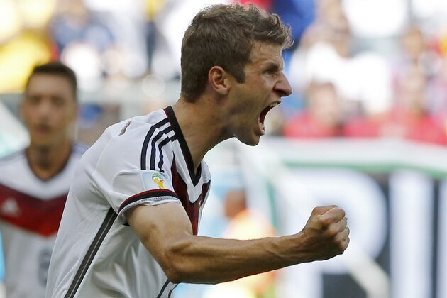 Germany's Thomas Mueller celebrates after scoring the opening goal during the group G World Cup soccer match between Germany and Portugal at the Arena Fonte Nova in Salvador, Brazil, Monday, June 16, 2014.  (AP Photo/Matthias Schrader)