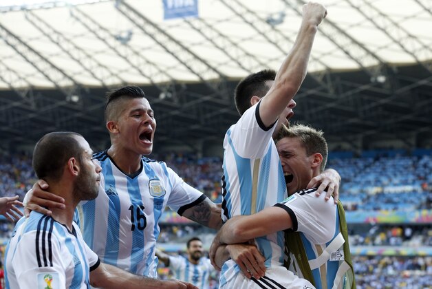 Argentina's Lionel Messi, second right, celebrates after scoring the first goal during the group F World Cup soccer match between Argentina and Iran at the Mineirao Stadium in Belo Horizonte, Brazil, Saturday, June 21, 2014. Argentina won 1-0.  (AP Photo/Jon Super)