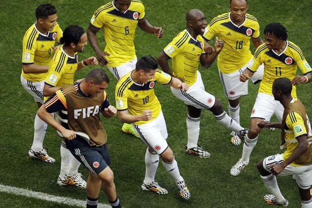 Colombia's James Rodriguez, center, dances with teammates in celebration after scoring during the group C World Cup soccer match between Colombia and Ivory Coast at the Estadio Nacional in Brasilia, Brazil, Thursday, June 19, 2014.  (AP Photo/Themba Hadebe)