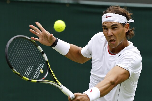 Rafael Nadal of Spain plays a return to Steve Darcis of Belgium during their Men's first round singles match at the All England Lawn Tennis Championships in Wimbledon, London, Monday, June 24, 2013. (AP Photo/Kirsty Wigglesworth)