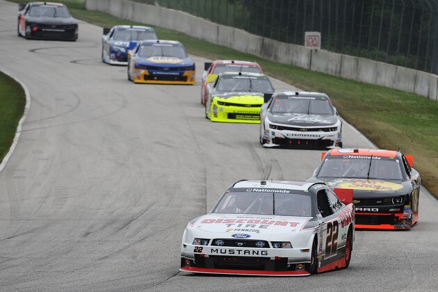 ELKHART LAKE, W.I. - JUNE 21: Alex Tagliani, driver of the #22 Discount Tire Ford, leads a pack of cars during the NASCAR Nationwide Series Gardner Denver 200 Fired Up by Johnsonville at Road America, June 21, 2014 in Elkhart Lake, Wisconsin. (Photo by Rainier Ehrhardt/Getty Images)