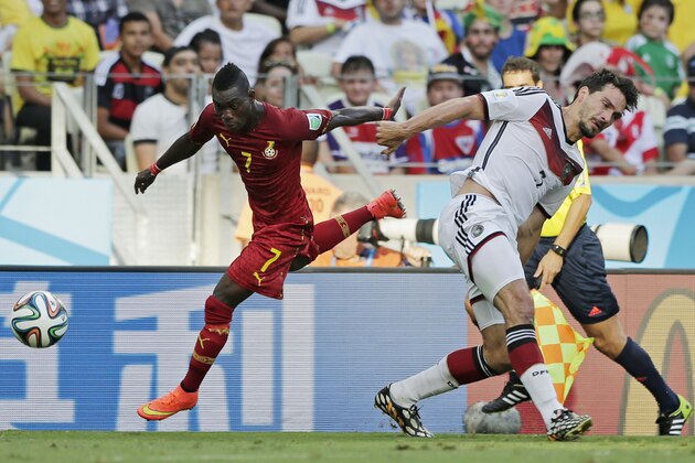 Ghana's Christian Atsu, left, gets away from Germany's Mats Hummels during the group G World Cup soccer match at the Arena Castelao in Fortaleza, Brazil, Saturday, June 21, 2014. (AP Photo/Matthias Schrader)