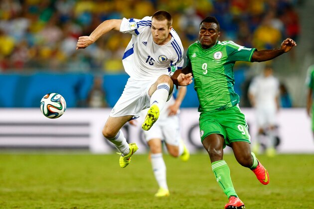 CUIABA, BRAZIL - JUNE 21:  Toni Sunjic of Bosnia and Herzegovina and Emmanuel Emenike of Nigeria compete for the ball during the 2014 FIFA World Cup Group F match between Nigeria and Bosnia-Herzegovina at Arena Pantanal on June 21, 2014 in Cuiaba, Brazil.  (Photo by Phil Walter/Getty Images)
