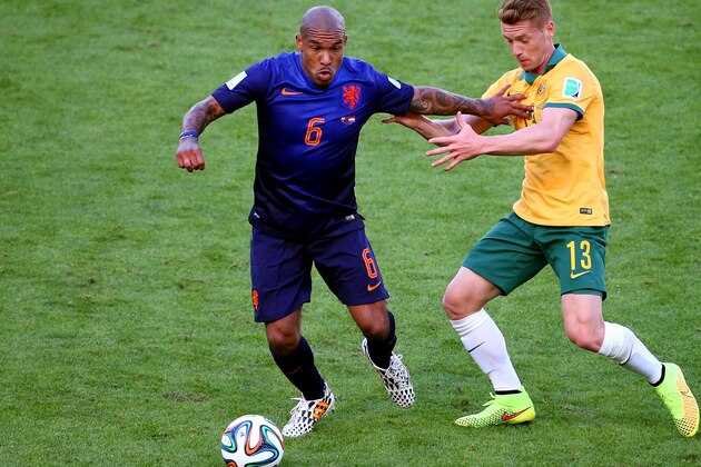 PORTO ALEGRE, BRAZIL - JUNE 18:  Nigel de Jong of the Netherlands and Oliver Bozanic of Australia compete for the ball during the 2014 FIFA World Cup Brazil Group B match between Australia and Netherlands at Estadio Beira-Rio on June 18, 2014 in Porto Alegre, Brazil.  (Photo by Paul Gilham/Getty Images)
