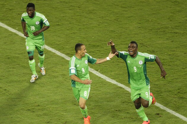 Nigeria's Peter Odemwingie, center, celebrates with his teammates Michael Babatunde, left, and Emmanuel Emenike after scoring the opening goal during the group F World Cup soccer match between Nigeria and Bosnia at the Arena Pantanal in Cuiaba, Brazil, Saturday, June 21, 2014. (AP Photo/Fernando Llano)