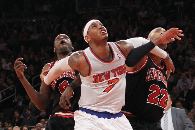 NEW YORK, NY - JANUARY 11:  Luol Deng #9 and Taj Gibson #22 of the Chicago Bulls combine to stop Carmelo Anthony #7 of the New York Knicks at Madison Square Garden on January 11, 2013 in New York City. NOTE TO USER: User expressly acknowledges and agrees that, by downloading and/or using this photograph, user is consenting to the terms and conditions of the Getty Images License Agreement. The Bulls defeated the Knicks 108-101.  (Photo by Bruce Bennett/Getty Images)