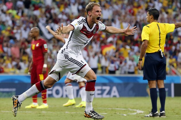 Germany's Benedikt Hoewedes celebrates after his teammate Miroslav Klose scored a goal during the group G World Cup soccer match between Germany and Ghana at the Arena Castelao in Fortaleza, Brazil, Saturday, June 21, 2014. (AP Photo/Matthias Schrader)