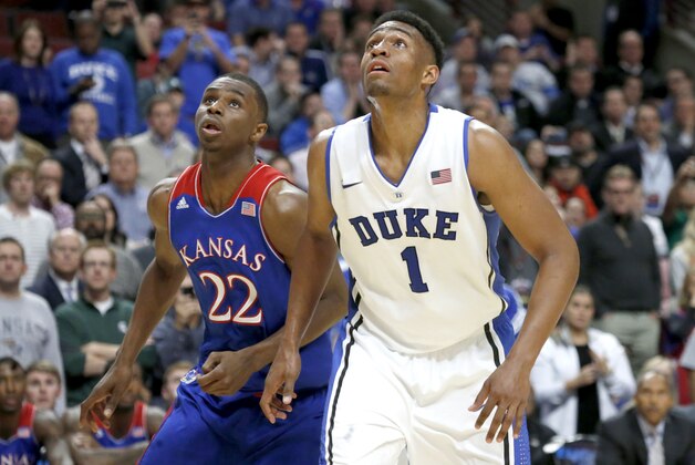 Duke forward Jabari Parker and Kansas guard Andrew Wiggins look for a possible rebound off a free-throw attempt during the second half of an NCAA college basketball game Tuesday, Nov. 12, 2013, in Chicago. Kansas won 94-83. (AP Photo/Charles Rex Arbogast)