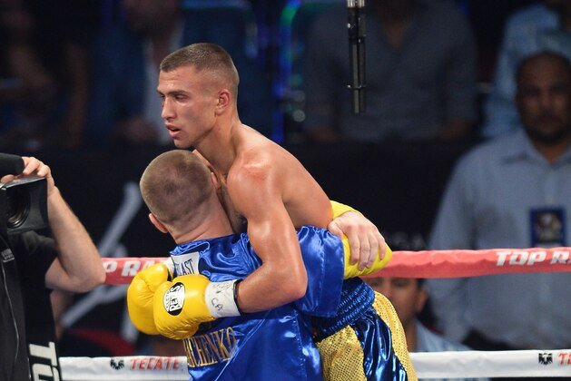 LAS VEGAS, NV - OCTOBER 12:  Vasyl Lomachenko is lifted in the ring as he celebrates his fourth-round TKO victory over Jose Ramirez in their their featherweight bout at the Thomas & Mack Center on October 12, 2013 in Las Vegas, Nevada.  (Photo by Ethan Miller/Getty Images)