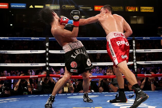 LOS ANGELES, CA - JUNE 21:  Robert Guerrero (R) lands a punch on Yoshihiro Kamegai in their welterweight bout at StubHub Center on June 21, 2014 in Los Angeles, California.  Guerrero won by unanimous decision.  (Photo by Stephen Dunn/Getty Images)