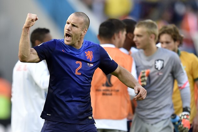 Netherlands' Ron Vlaar celebrates after the group B World Cup soccer match between Australia and the Netherlands at the Estadio Beira-Rio in Porto Alegre, Brazil, Wednesday, June 18, 2014.  The Netherlands won the match 3-2.    (AP Photo/Martin Meissner)