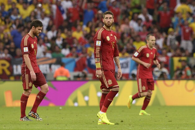 From left: Spain's Xabi Alonso, Sergio Ramos and Andres Iniesta leave the field at half time during the group B World Cup soccer match between Spain and Chile at the Maracana Stadium in Rio de Janeiro, Brazil, Wednesday, June 18, 2014.  (AP Photo/Manu Fernandez)