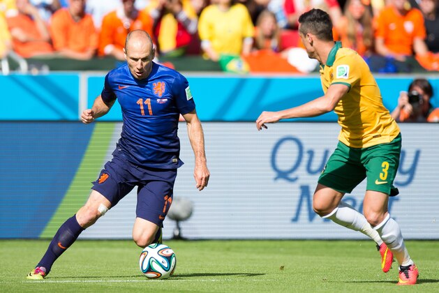 PORTO ALEGRE, BRAZIL - JUNE 18:  Arjen Robben of the Netherlands and Jason Davidson of Australia compete for the ball during the 2014 FIFA World Cup Brazil Group B match between Australia and Netherlands at Estadio Beira-Rio on June 18, 2014 in Porto Alegre, Brazil.  (Photo by Vinicius Costa/Getty Images)